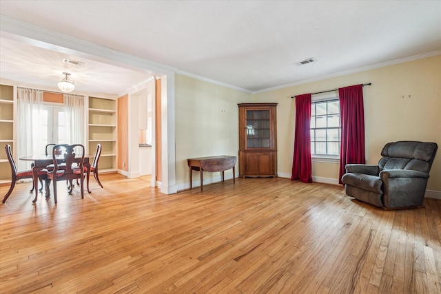 sitting room with light hardwood / wood-style floors, plenty of natural light, and ornamental molding