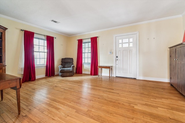 foyer entrance with crown molding and light wood-type flooring