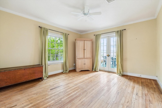 unfurnished room with french doors, ornamental molding, and light hardwood / wood-style flooring