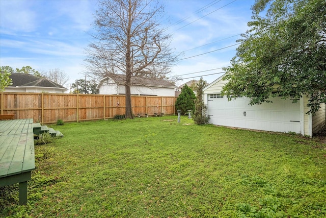 view of yard featuring an outdoor structure and a garage