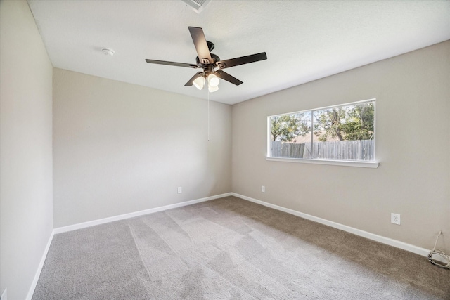 carpeted spare room with ceiling fan