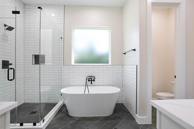 bathroom featuring toilet, independent shower and bath, tile walls, and tile patterned floors