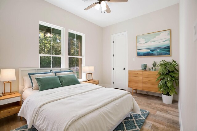 bedroom with ceiling fan and light hardwood / wood-style flooring