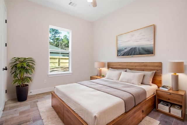 bedroom with ceiling fan and hardwood / wood-style flooring