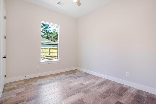 unfurnished room with ceiling fan and light wood-type flooring