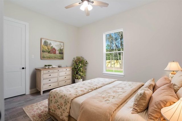 bedroom with ceiling fan and dark hardwood / wood-style floors