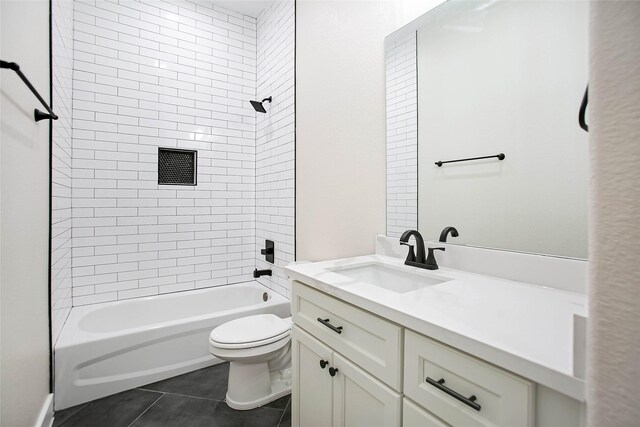 full bathroom featuring toilet, vanity, tiled shower / bath, and tile patterned flooring