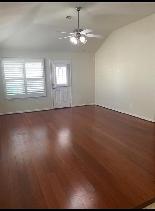 empty room featuring lofted ceiling, ceiling fan, and dark hardwood / wood-style floors