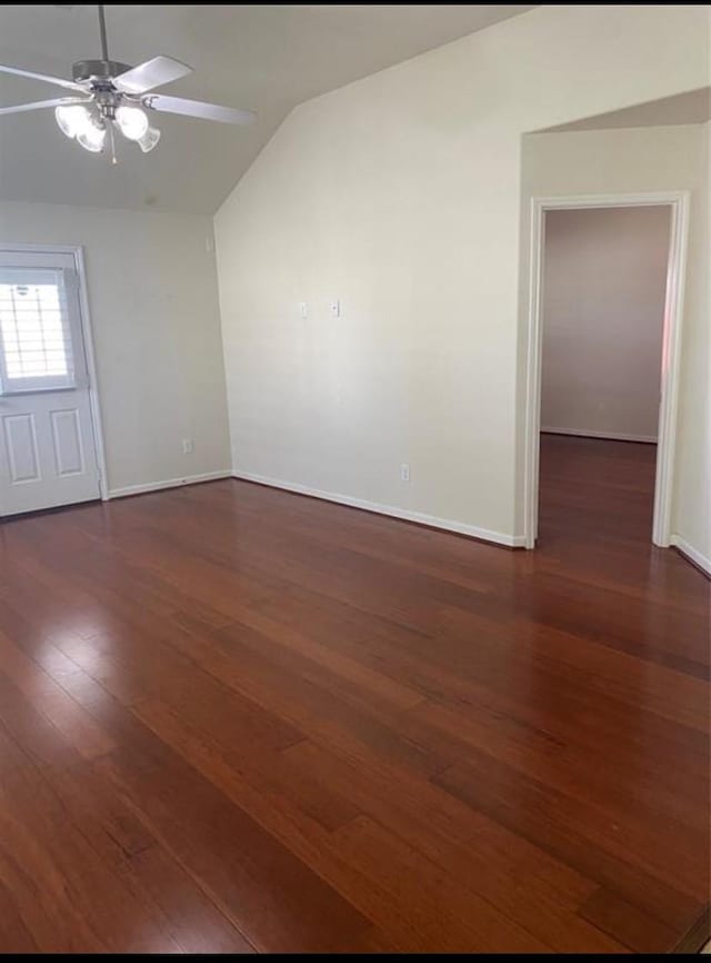 spare room with ceiling fan, vaulted ceiling, and dark hardwood / wood-style floors