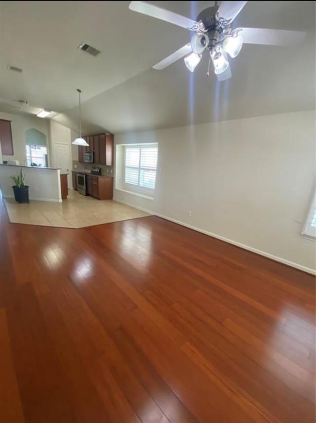 unfurnished living room with light wood-type flooring, ceiling fan, and lofted ceiling