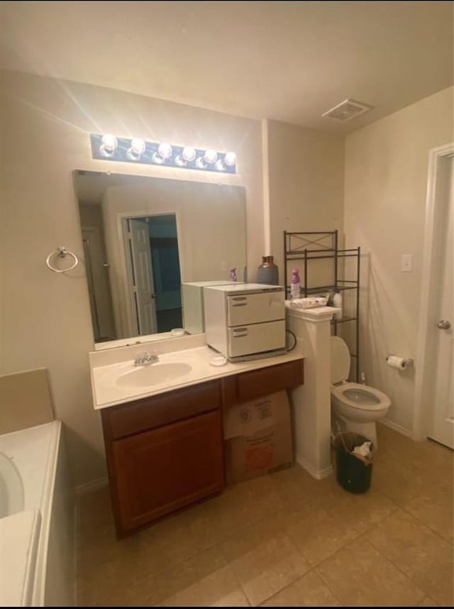 bathroom with tile patterned floors, vanity, and toilet