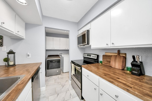 kitchen with separate washer and dryer, appliances with stainless steel finishes, wood counters, white cabinetry, and sink