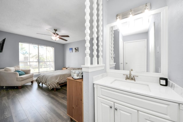 bathroom featuring ceiling fan, vanity, a textured ceiling, and hardwood / wood-style flooring