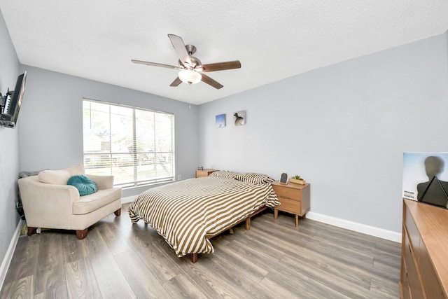 bedroom with ceiling fan and hardwood / wood-style flooring