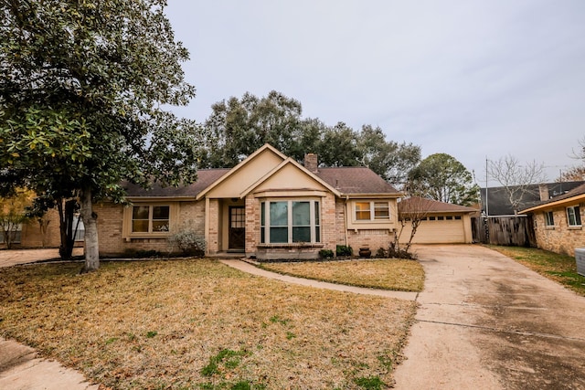 single story home with a garage and a front yard