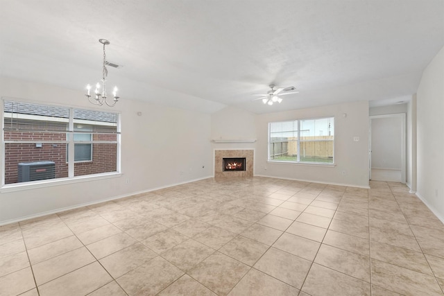 unfurnished living room with a tiled fireplace, ceiling fan with notable chandelier, light tile patterned floors, and lofted ceiling