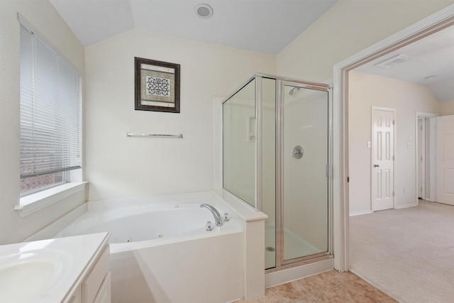 bathroom with vanity, lofted ceiling, and separate shower and tub