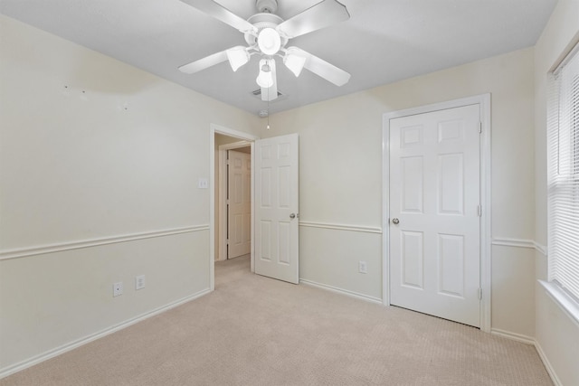 unfurnished bedroom featuring ceiling fan and light colored carpet