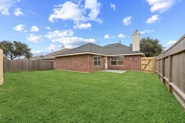 rear view of house with a yard and a patio