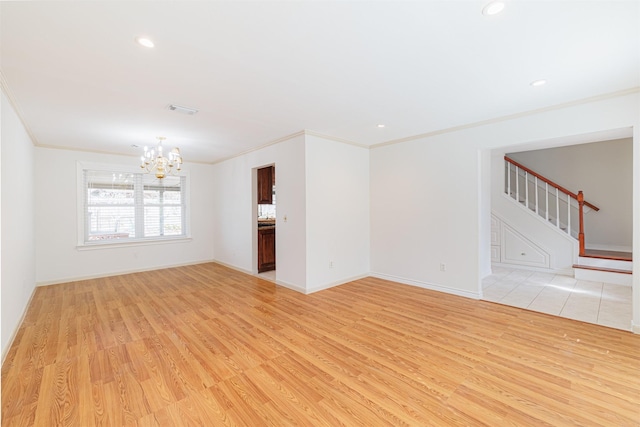 unfurnished living room with crown molding, light hardwood / wood-style floors, and a notable chandelier