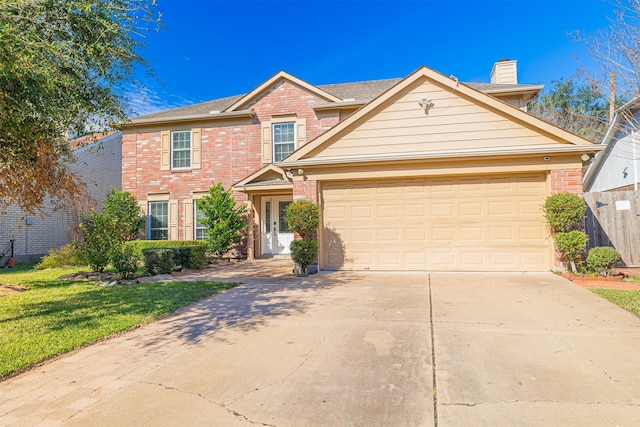 view of front of home with a front lawn and a garage