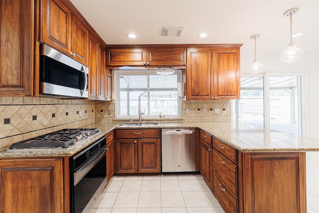 kitchen with backsplash, pendant lighting, kitchen peninsula, stainless steel appliances, and light tile patterned floors