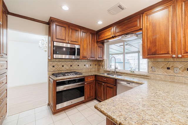 kitchen with stainless steel appliances, tasteful backsplash, crown molding, light stone counters, and sink