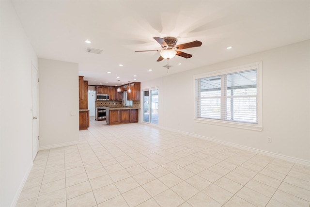 unfurnished living room featuring ceiling fan and light tile patterned floors