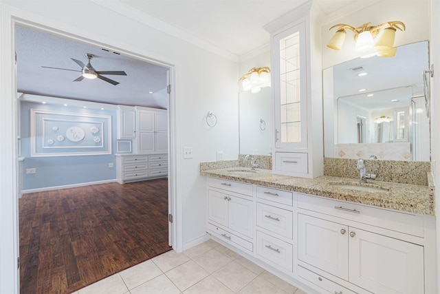 bathroom featuring ceiling fan, tile patterned flooring, crown molding, and vanity