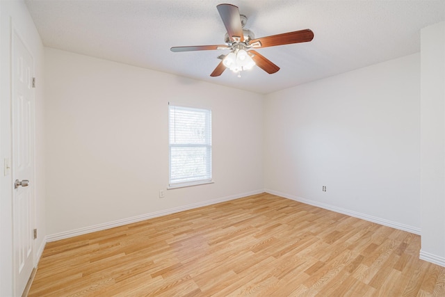 empty room featuring ceiling fan and light hardwood / wood-style flooring