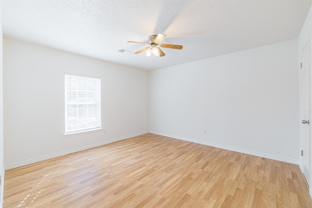 unfurnished room featuring ceiling fan, a textured ceiling, and light hardwood / wood-style flooring