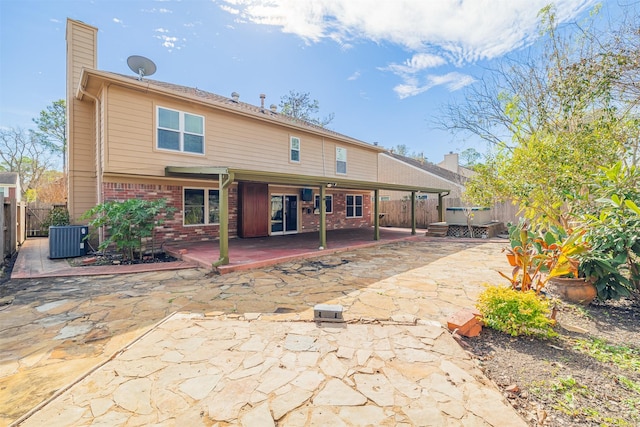 back of property featuring cooling unit and a patio