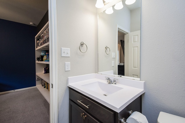 bathroom featuring toilet and vanity