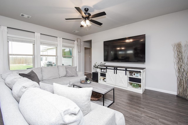 living room with ceiling fan and dark hardwood / wood-style flooring