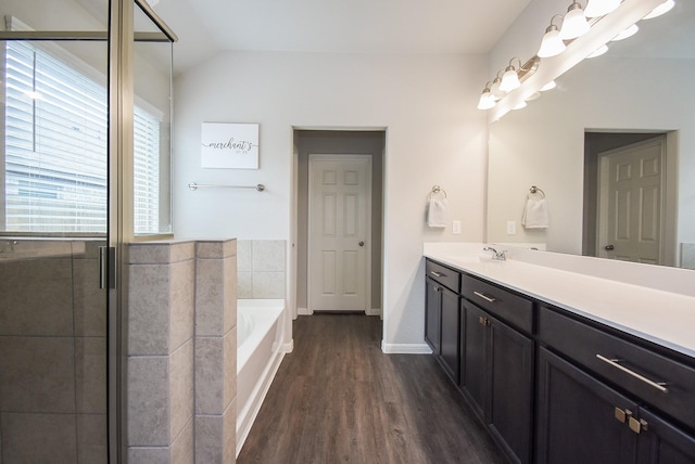 bathroom with separate shower and tub, vanity, vaulted ceiling, and hardwood / wood-style flooring