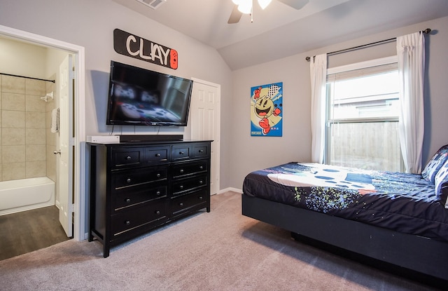 carpeted bedroom with ensuite bath, ceiling fan, and lofted ceiling