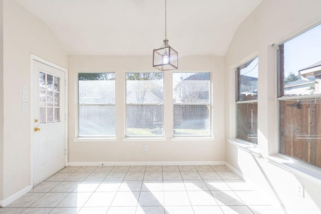 unfurnished sunroom featuring a healthy amount of sunlight and lofted ceiling