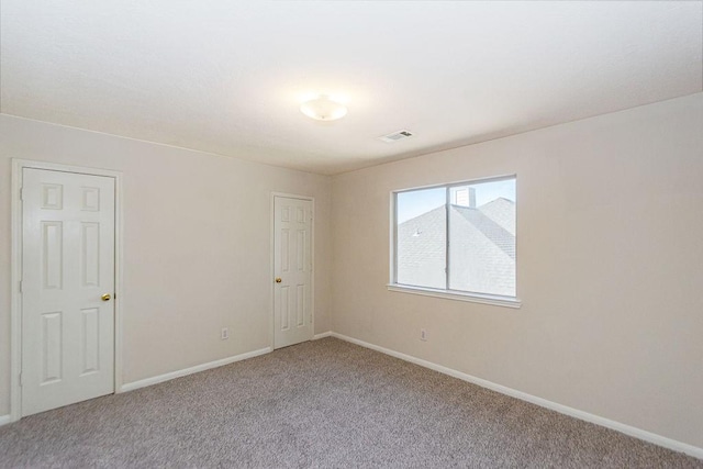 empty room featuring light carpet