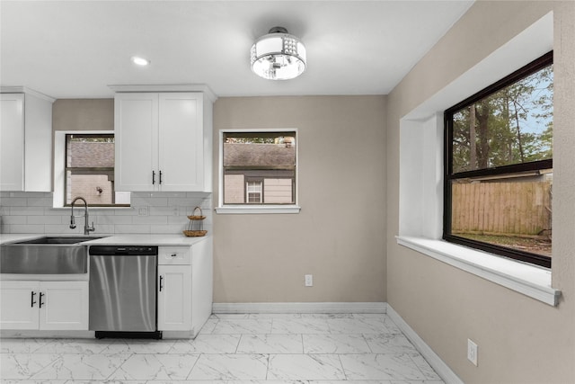 kitchen featuring decorative backsplash, sink, white cabinets, and dishwasher