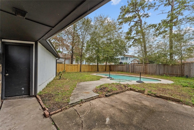 view of yard featuring a fenced in pool and a patio area