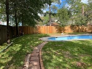 view of yard with a fenced in pool