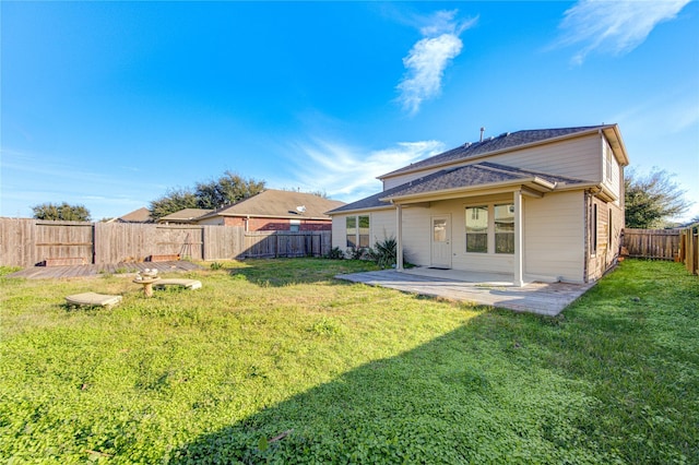 back of property with a patio area and a yard