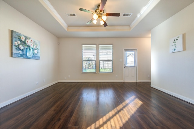 unfurnished room with ceiling fan, dark wood-type flooring, a tray ceiling, and crown molding