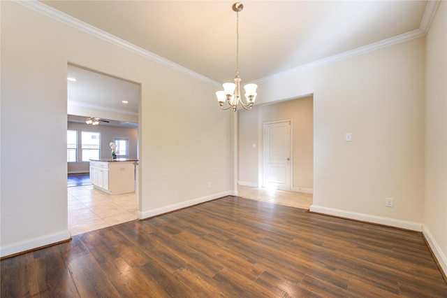 empty room featuring ornamental molding, ceiling fan with notable chandelier, and light hardwood / wood-style flooring