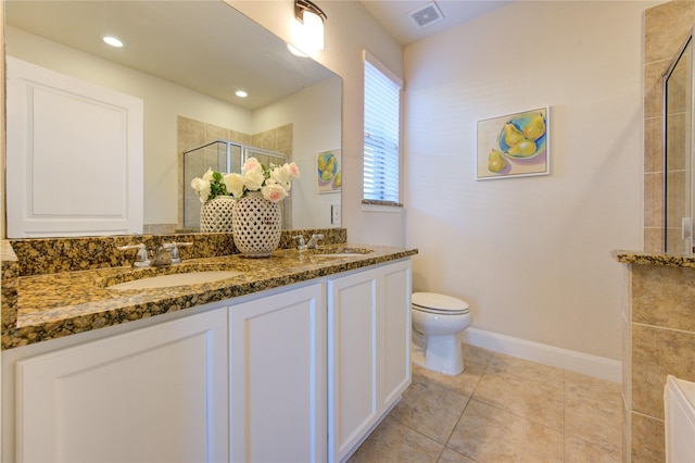 bathroom featuring a shower with shower door, vanity, tile patterned flooring, and toilet