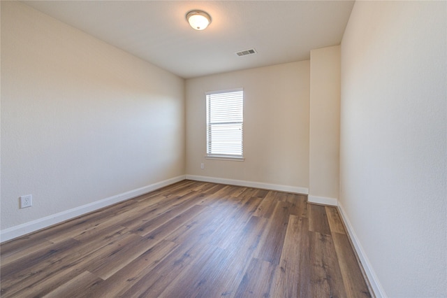 unfurnished room featuring dark hardwood / wood-style flooring