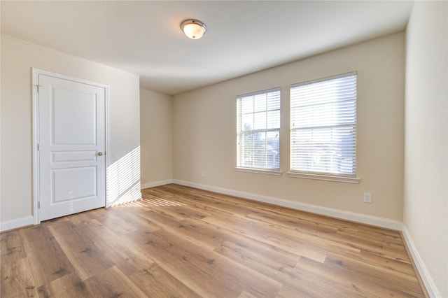 empty room with light hardwood / wood-style floors