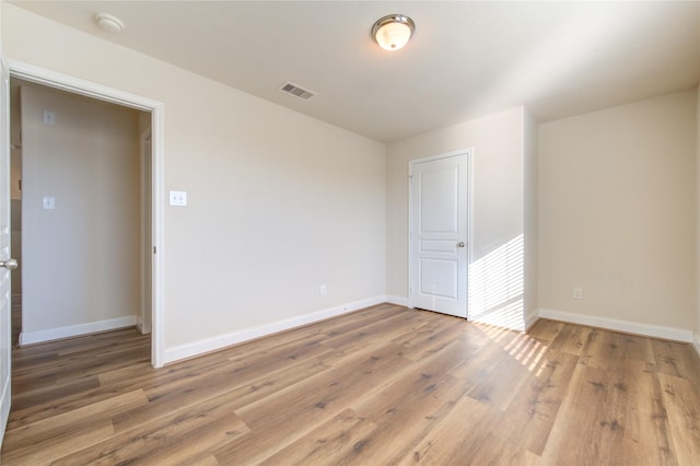 unfurnished room with hardwood / wood-style flooring