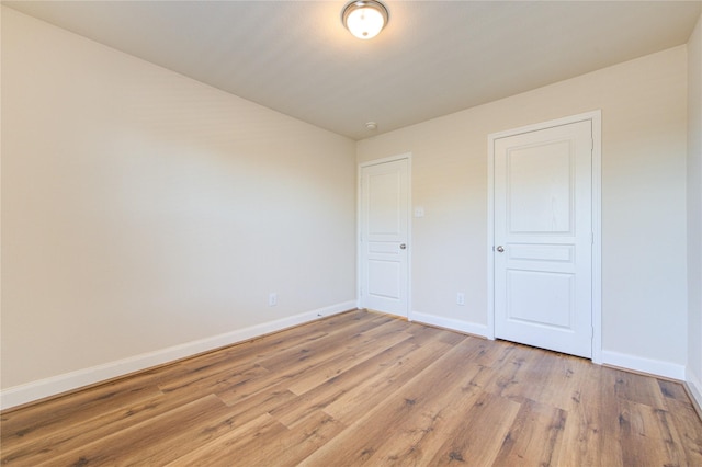 unfurnished bedroom featuring light hardwood / wood-style flooring and a closet