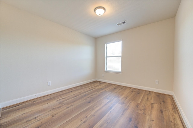 empty room with hardwood / wood-style floors